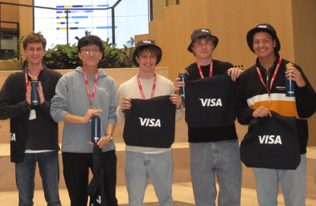 Holding Visa tote bags with the team after an industry workshop